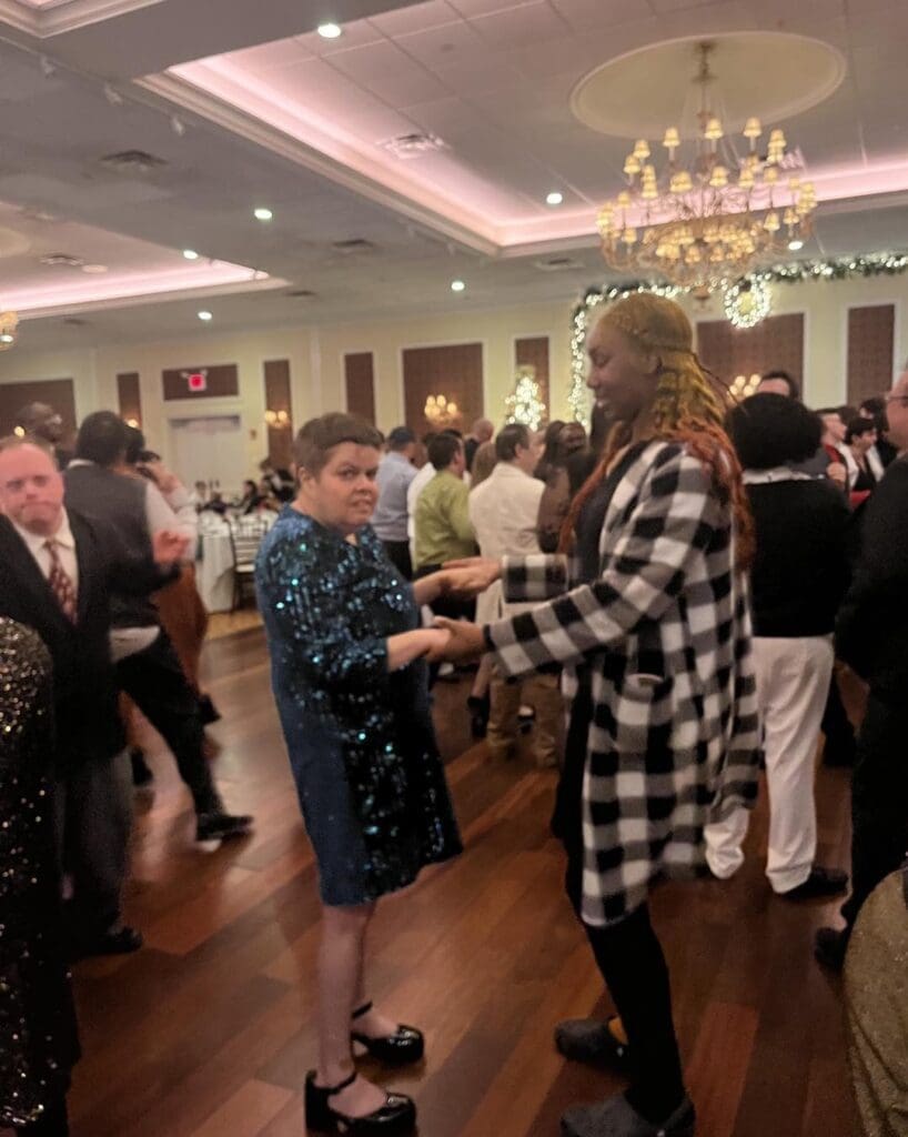 Participant and Direct Support Professional Dancing Together