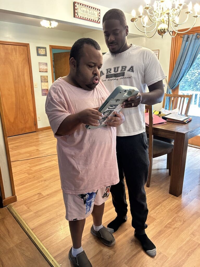 Two men reading a magazine in a cozy living room.