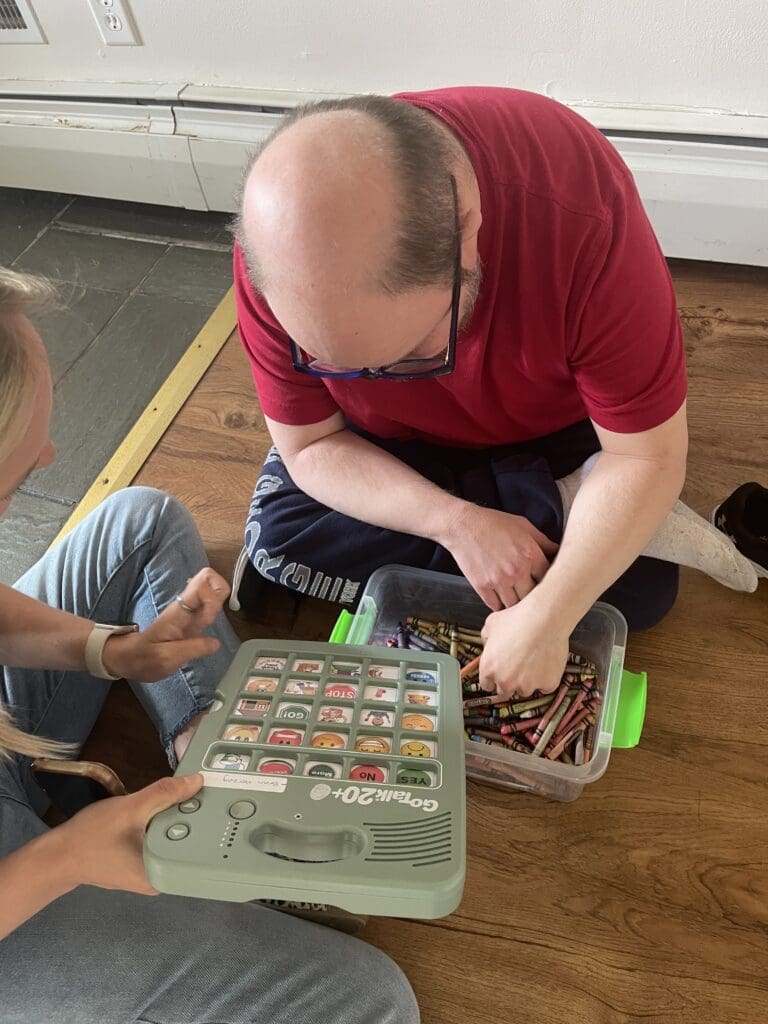 Adult and child playing a board game on the floor.