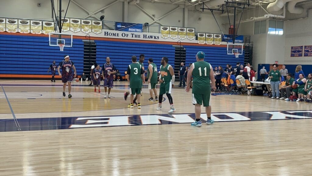 High school basketball game in progress inside a gymnasium.