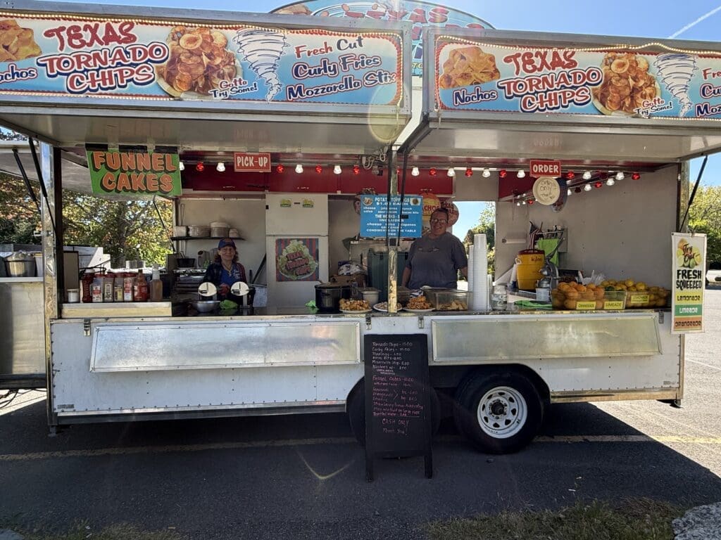 Food truck serving Texas barbecue with customers ordering.