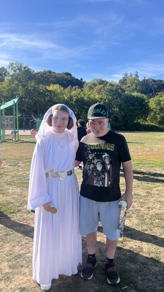 Two people outdoors, one dressed as Princess Leia.