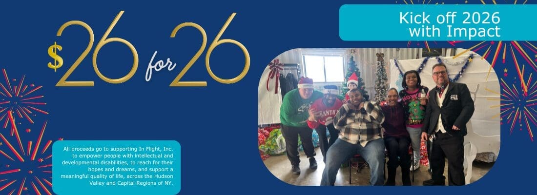 Two people celebrating Christmas indoors, one wearing a green sweater and the other in a plaid shirt.