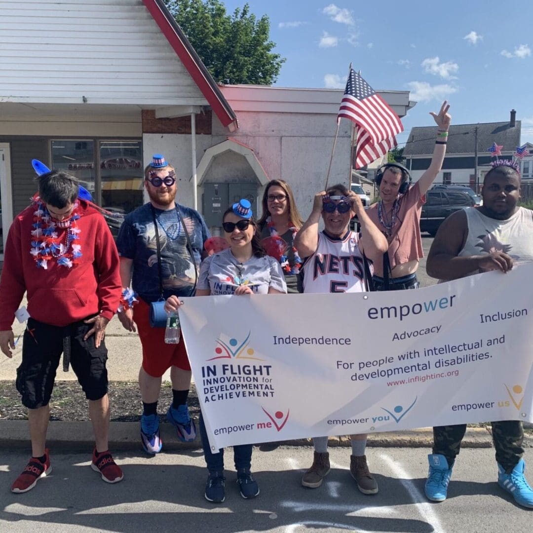 Hudson Flag Day Parade - In Flight, Inc. Programs holding banner